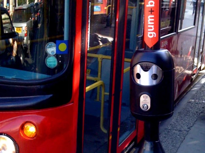 Smartbin alongside a passing London bus