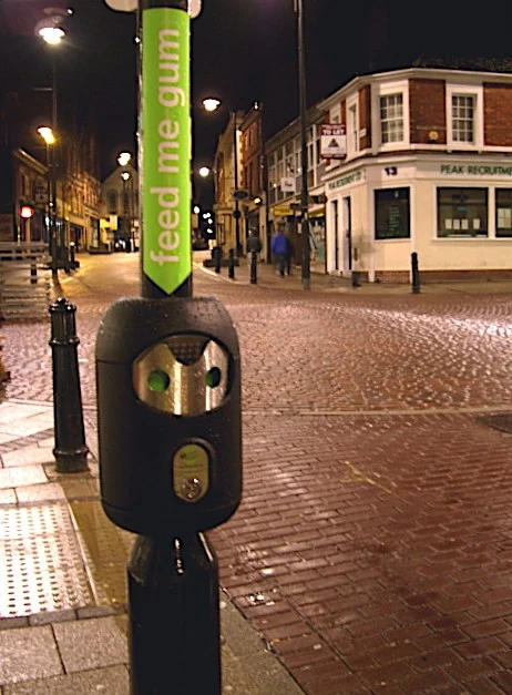 Smartbin and illuminated signage photographed at night